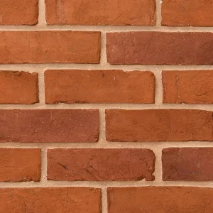 A close up of bricks arranged horizontally, featuring light-coloured mortar with orange tones
