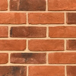 A close-up view of a brick wall featuring I0020: Country Blend bricks with a reddish-brown hue and light-coloured mortar.