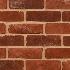 a textured red brick wall with tan mortar and bricks laid in a horizontal pattern.
