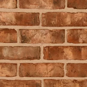 Brick wall, featuring light mortar between bricks to highlight the masonry’s texture and pattern.