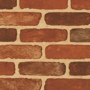 Red and brown tones of a brick wall sample laid in uniform pattern showing mortar joints