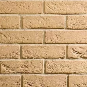 Buff coloured bricks laid in a stretcher pattern for a wall