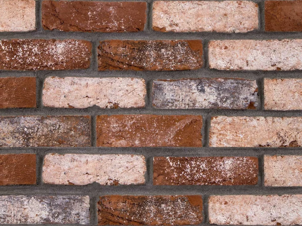 Bricks in alternating courses of red and light brown tones, separated by grey mortar.