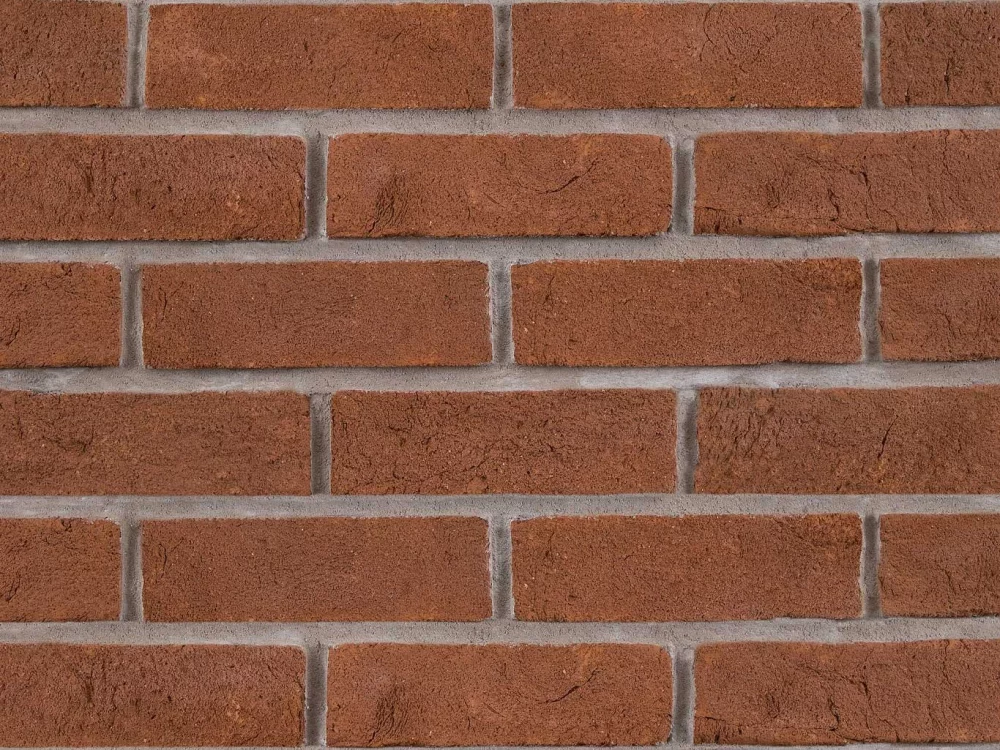 A red brick featuring evenly spaced rectangular bricks and visible horizontal and vertical mortar lines.
