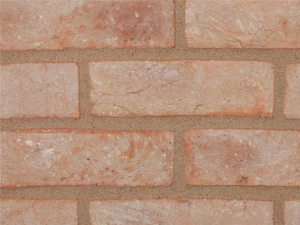 A buff brick laid in stretcher bond with light coloured mortar