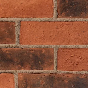 A brick panel wall with orange tones laid in a stretcher pattern with light coloured mortar