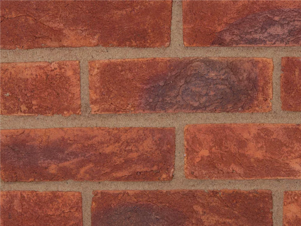 Red tone bricks laid in a pattern with lighter coloured mortar