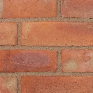 An orange brick with light coloured mortar laid in a traditional pattern