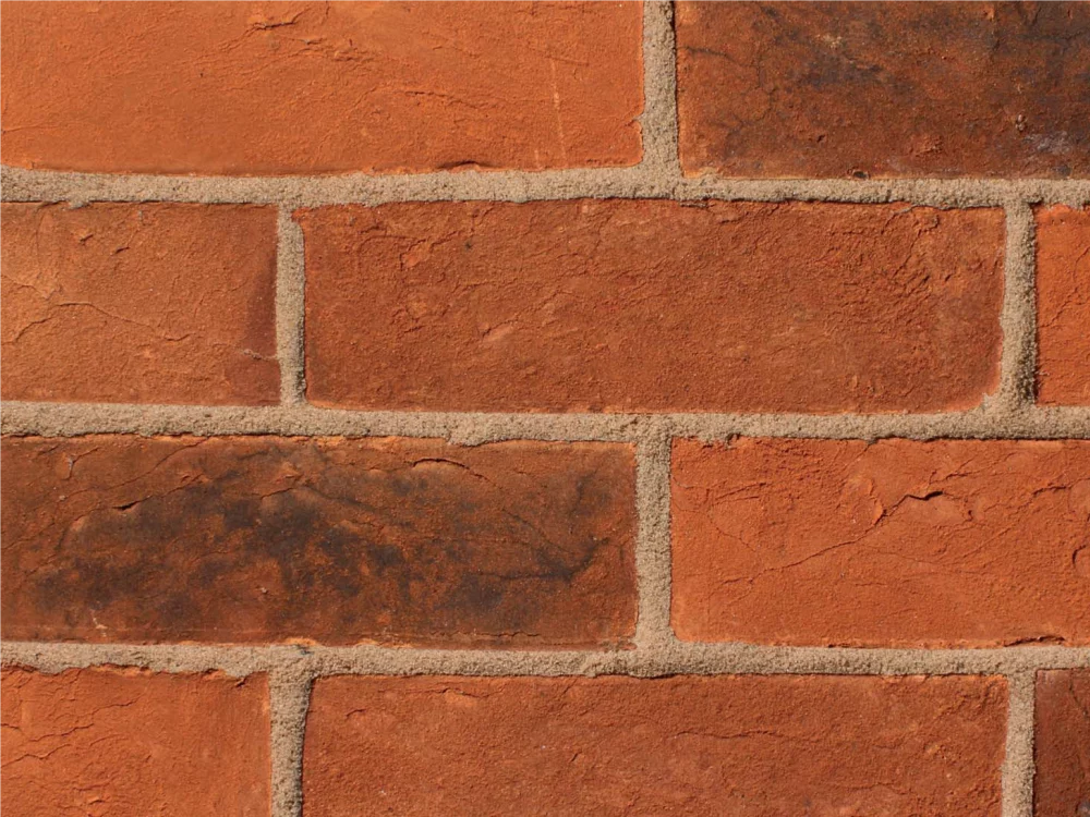 Red bricks laid in a traditional stretcher pattern with light mortar