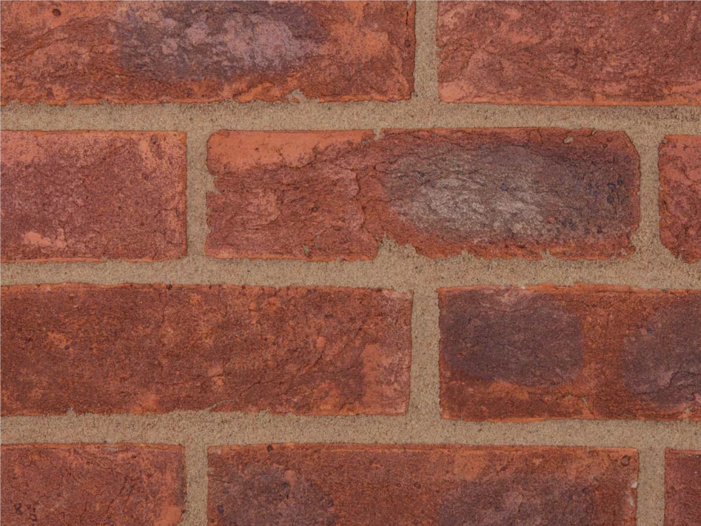 Red brick wall with light mortar laid in a stretcher pattern