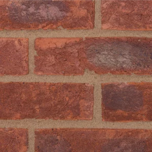 Red brick wall with light mortar laid in a stretcher pattern
