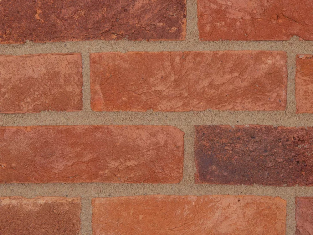 A red and orange brick and is laid in a traditional pattern with light mortar lines