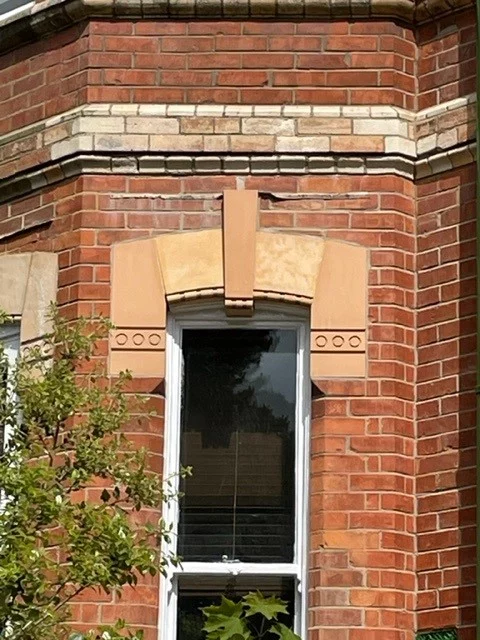 Natural stone keystone arch surrounding original sash window