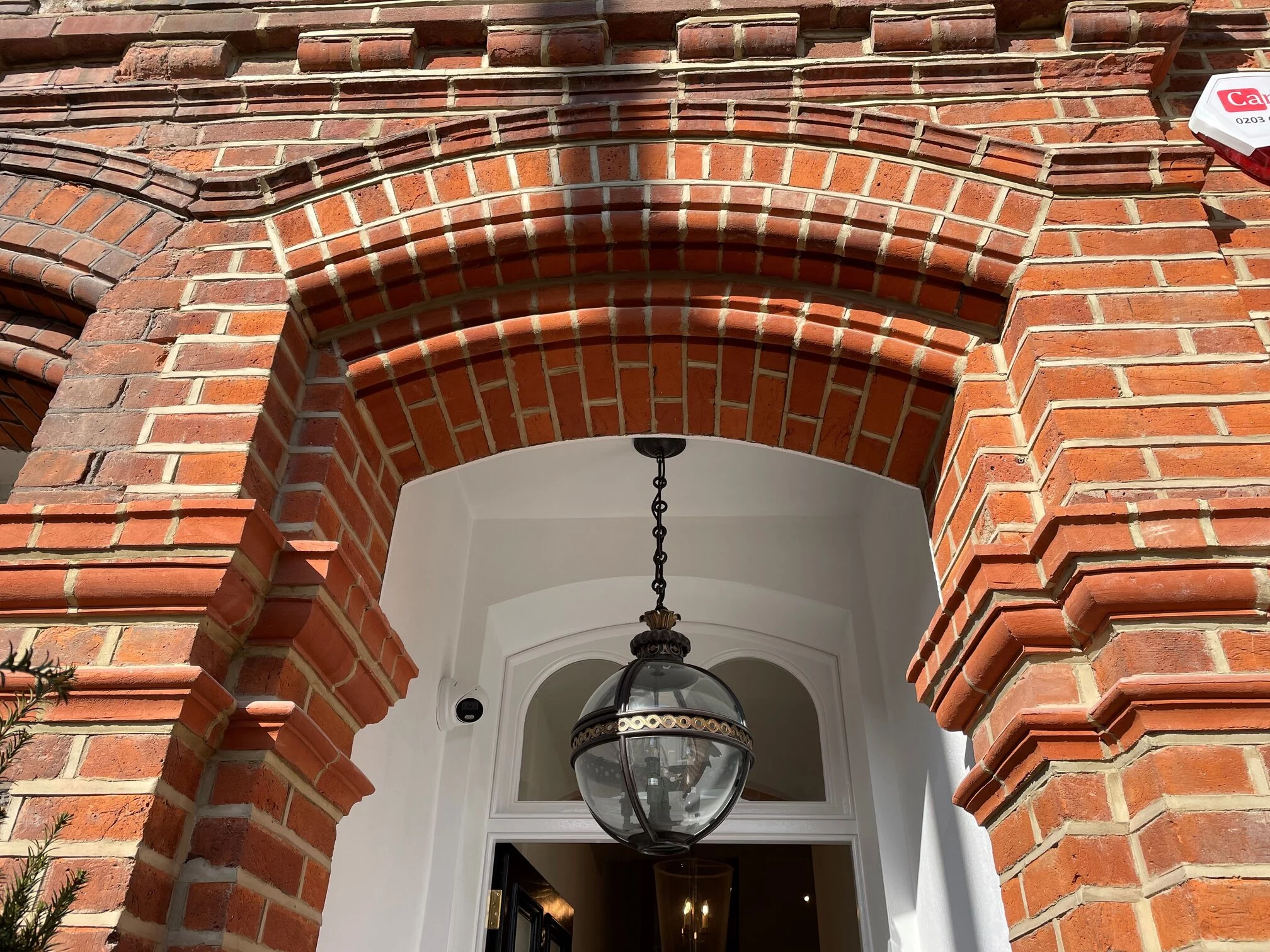 Pre-fabricated brick arch and brick specials sat within a traditional front entrance