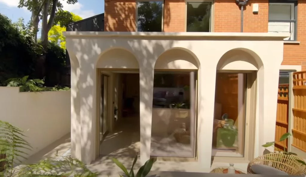 Three natural stone arches surround a garden entrance to the property