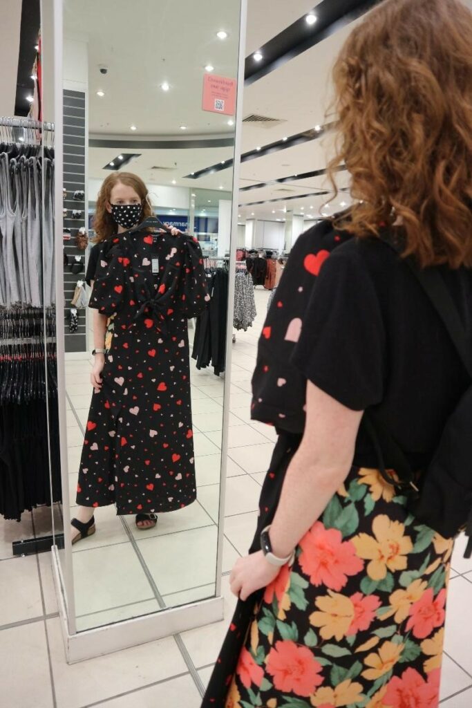 EllisTuesday trying on black dress with heart prints