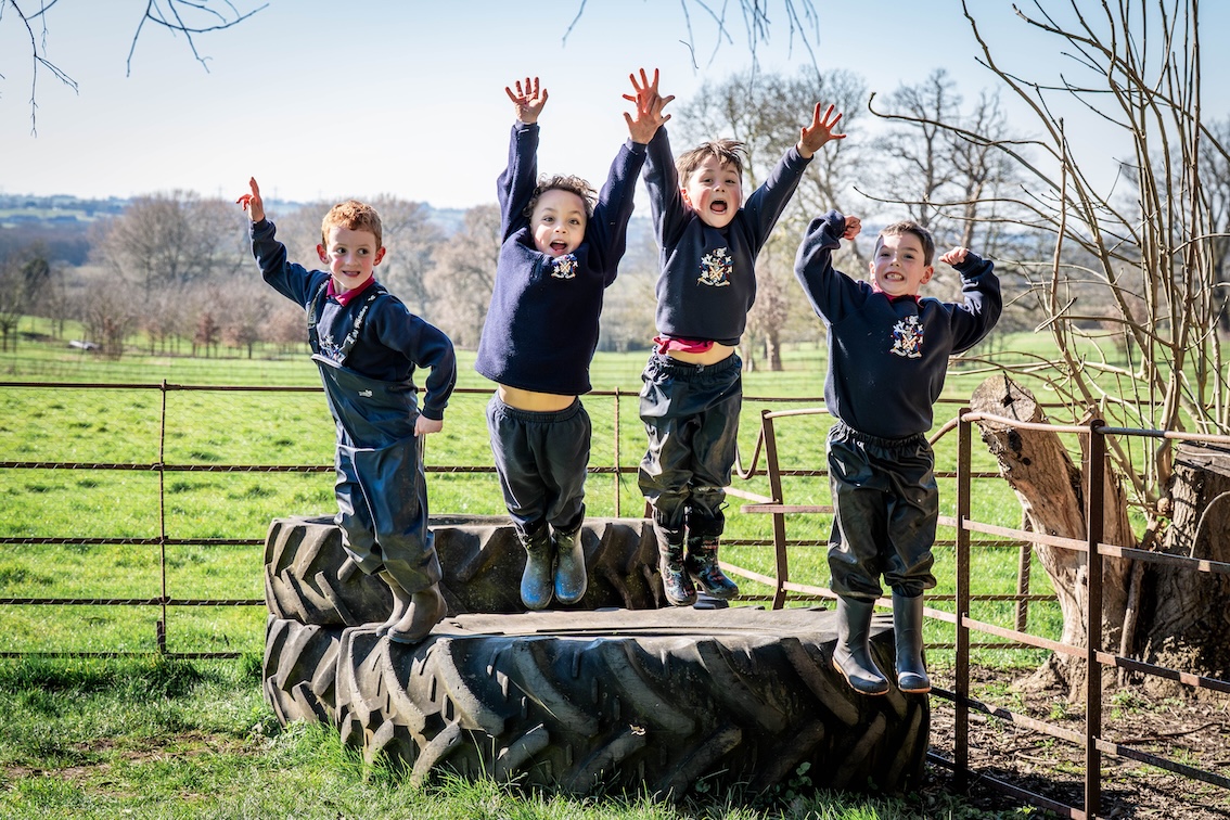 Four Reception pupils having fun outdoors | School Portal | Swanbourne House